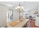 Elegant dining room with a chandelier, bright walls, and hardwood floors at 417 Jeffers St, Deltona, FL 32725