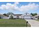 Charming single-story home with a well-maintained lawn and a two-car garage at 417 Jeffers St, Deltona, FL 32725