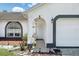 Inviting front porch with decorative accents and a well-manicured garden at 417 Jeffers St, Deltona, FL 32725