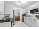 Bright kitchen featuring white cabinets, tile floors, and stainless steel appliances at 417 Jeffers St, Deltona, FL 32725