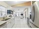 Open-concept kitchen with stainless steel appliances and a seamless flow to living area at 417 Jeffers St, Deltona, FL 32725