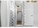 Clean-looking tiled shower with seamless glass door, and decorative wall paper at 417 Jeffers St, Deltona, FL 32725