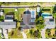 An aerial view of a well-maintained property with a backyard pool, green grass and patio area at 426 N Boyd St, Winter Garden, FL 34787