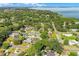 Expansive aerial view showcases the property among lush trees and tranquil lake in a charming neighborhood at 426 N Boyd St, Winter Garden, FL 34787