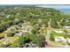 Expansive aerial view showcases the property among lush trees and tranquil lake in a charming neighborhood at 426 N Boyd St, Winter Garden, FL 34787