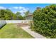 Grassy backyard with raised garden beds and mature landscaping, providing a serene outdoor space for the home at 426 N Boyd St, Winter Garden, FL 34787