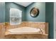 The bathroom features a corner soaking tub, tile flooring, and a window at 426 N Boyd St, Winter Garden, FL 34787