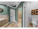 This bathroom features a corner soaking tub, tile flooring, a walk in shower, and toilet at 426 N Boyd St, Winter Garden, FL 34787