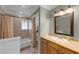 Bathroom features a shower and bathtub with a wood style floor and a tile backsplash behind the countertop at 426 N Boyd St, Winter Garden, FL 34787