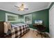 Comfortable bedroom with desk, ceiling fan, and natural light from the windows at 426 N Boyd St, Winter Garden, FL 34787