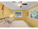 Yellow bedroom with a ceiling fan, a view of the pool, and plenty of natural light at 426 N Boyd St, Winter Garden, FL 34787