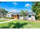 Charming home with well-manicured landscaping, a cozy screened porch, and a welcoming front entrance at 426 N Boyd St, Winter Garden, FL 34787