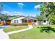 Charming home featuring a curved walkway, mature trees, and a cozy screened front porch entrance at 426 N Boyd St, Winter Garden, FL 34787