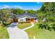 Charming home featuring a curved walkway, mature trees, and a cozy screened front porch entrance at 426 N Boyd St, Winter Garden, FL 34787