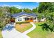 Charming home featuring a curved walkway, mature trees, and a cozy screened front porch entrance at 426 N Boyd St, Winter Garden, FL 34787