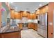 Well-equipped kitchen featuring stainless steel appliances, granite countertops, and wooden cabinets at 426 N Boyd St, Winter Garden, FL 34787