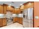 This kitchen has stainless steel appliances, tiled floors, and wooden cabinets at 426 N Boyd St, Winter Garden, FL 34787