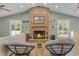 Inviting living room featuring a stone fireplace, beamed ceiling, and plenty of natural light at 426 N Boyd St, Winter Garden, FL 34787
