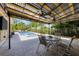 Covered patio featuring an outdoor seating area and a nearby swimming pool and hot tub at 426 N Boyd St, Winter Garden, FL 34787