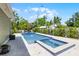 Backyard pool and hot tub combination with an adjacent patio area and green foliage at 426 N Boyd St, Winter Garden, FL 34787