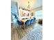Bright dining room features a wood table, seating for six, with decor shelf and modern light fixture at 4339 Northern Dancer Way, Orlando, FL 32826