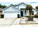 Attractive single-story home featuring a two-car garage, a blue front door, and modern landscaping at 4339 Northern Dancer Way, Orlando, FL 32826