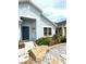 Inviting front entrance with a dark blue door, decorative accents, and stone landscaping at 4339 Northern Dancer Way, Orlando, FL 32826
