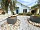 Charming home featuring a beautifully landscaped front yard with rock features and unique planters at 4339 Northern Dancer Way, Orlando, FL 32826