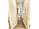 Hallway leading to the kitchen with wood-look flooring and white trim at 4339 Northern Dancer Way, Orlando, FL 32826