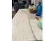 Close-up of the kitchen island's quartz countertop, showcasing its unique veining and color at 4339 Northern Dancer Way, Orlando, FL 32826