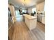 Modern kitchen features a center island, stainless steel appliances, and a view to the living area at 4339 Northern Dancer Way, Orlando, FL 32826