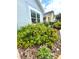 Lush landscaping with colorful flowering bushes surrounding the exterior of the home at 4339 Northern Dancer Way, Orlando, FL 32826