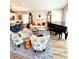 Open-concept living room with modern furniture, a piano, and a dining area at 4339 Northern Dancer Way, Orlando, FL 32826