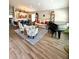 An open-concept living room, showcasing the dining area, comfortable seating, and a grand piano at 4339 Northern Dancer Way, Orlando, FL 32826