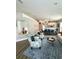 Inviting living room features a blue patterned rug, floral chairs, and an open view of the dining area at 4339 Northern Dancer Way, Orlando, FL 32826