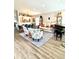 Spacious open-plan living room with a piano, modern seating, and laminate floors at 4339 Northern Dancer Way, Orlando, FL 32826