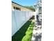 Side yard with green lawn and new white fence at 4339 Northern Dancer Way, Orlando, FL 32826