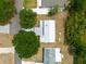 An aerial view of a home with a metal roof, showcasing its location among trees and nearby streets at 44 Florence Blvd, Debary, FL 32713