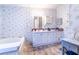 Bathroom featuring floral wallpaper, white vanity, and a bathtub at 44 Florence Blvd, Debary, FL 32713
