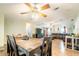 A view of a dining table with chairs, flowing into a living area, enhancing the home's spacious feel at 44 Florence Blvd, Debary, FL 32713