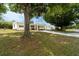 Well-maintained home featuring lush greenery and a covered carport, exuding curb appeal at 44 Florence Blvd, Debary, FL 32713