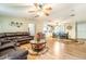 A view of a comfortable living room with a leather sofa and decorative elements, open to the dining area at 44 Florence Blvd, Debary, FL 32713