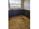An interior room with faux brick and wood paneling, a window, and damaged floor at 461 Marigold Rd, Casselberry, FL 32707