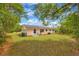 Spacious backyard featuring lush lawn, trees, and a view of the home's exterior at 508 W Hogle Ave, Deland, FL 32720