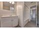 Clean bathroom with tiled walls and flooring, vanity and bathtub with shower, leading into the hallway at 508 W Hogle Ave, Deland, FL 32720