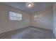 Bedroom with carpeting, two windows with blinds, neutral paint and ample natural light at 508 W Hogle Ave, Deland, FL 32720