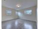 This large bedroom is brightened by two windows and finished with carpet at 508 W Hogle Ave, Deland, FL 32720
