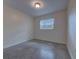 Bright bedroom features a window, neutral walls, and carpeted floors at 508 W Hogle Ave, Deland, FL 32720