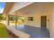 Covered carport area featuring a freshly painted floor, and brick accents at 508 W Hogle Ave, Deland, FL 32720