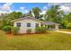 Single-story home featuring manicured landscaping, a new roof, and a covered carport at 508 W Hogle Ave, Deland, FL 32720